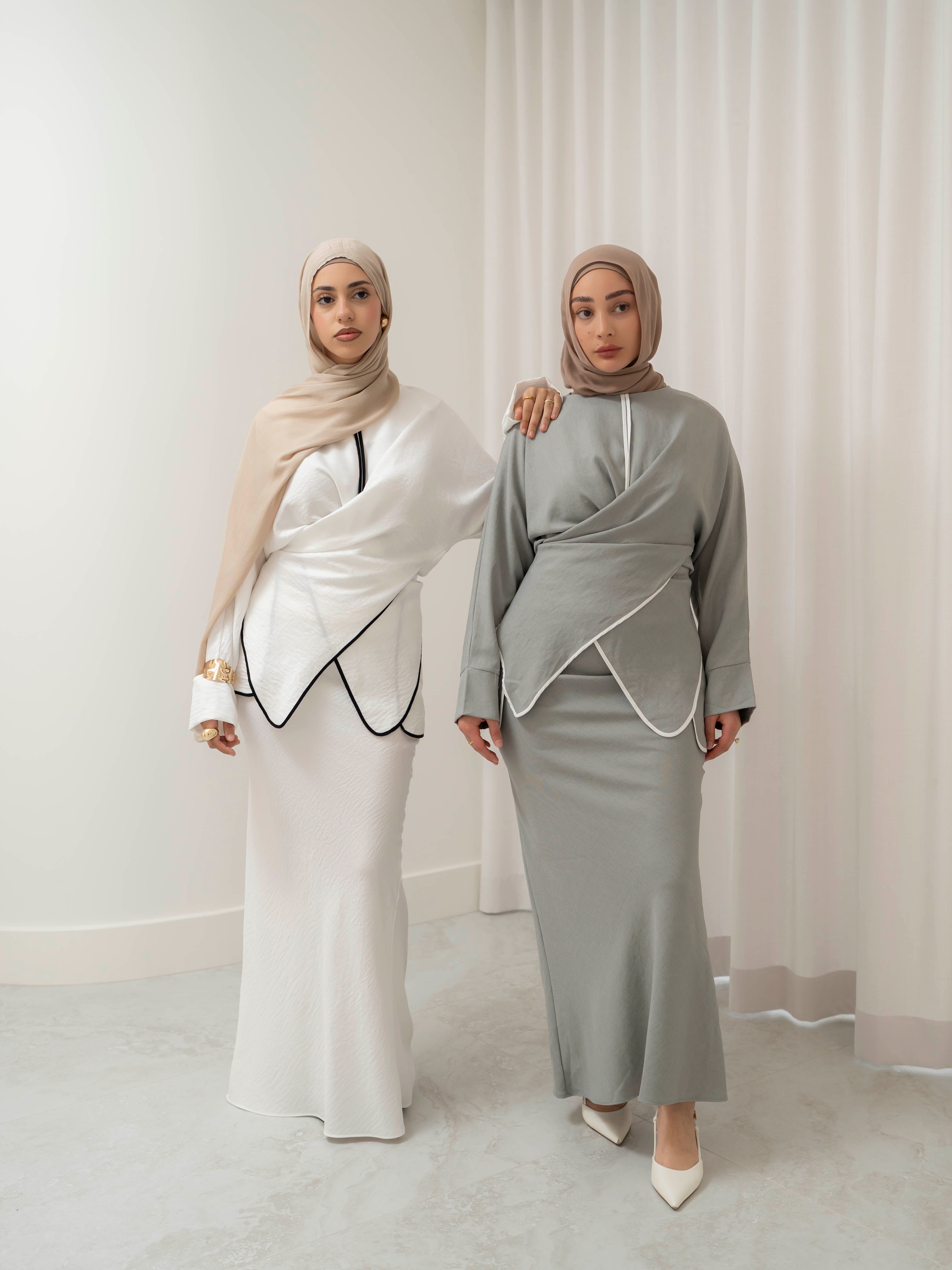Sienna Wrap Set, a two-piece outfit with a wrap-style tie top featuring contrast piping and long sleeves, paired with a full-length flowing skirt. Lightweight fabric drapes elegantly for a modest, refined silhouette suitable for Eid, special occasions, or versatile everyday wear.