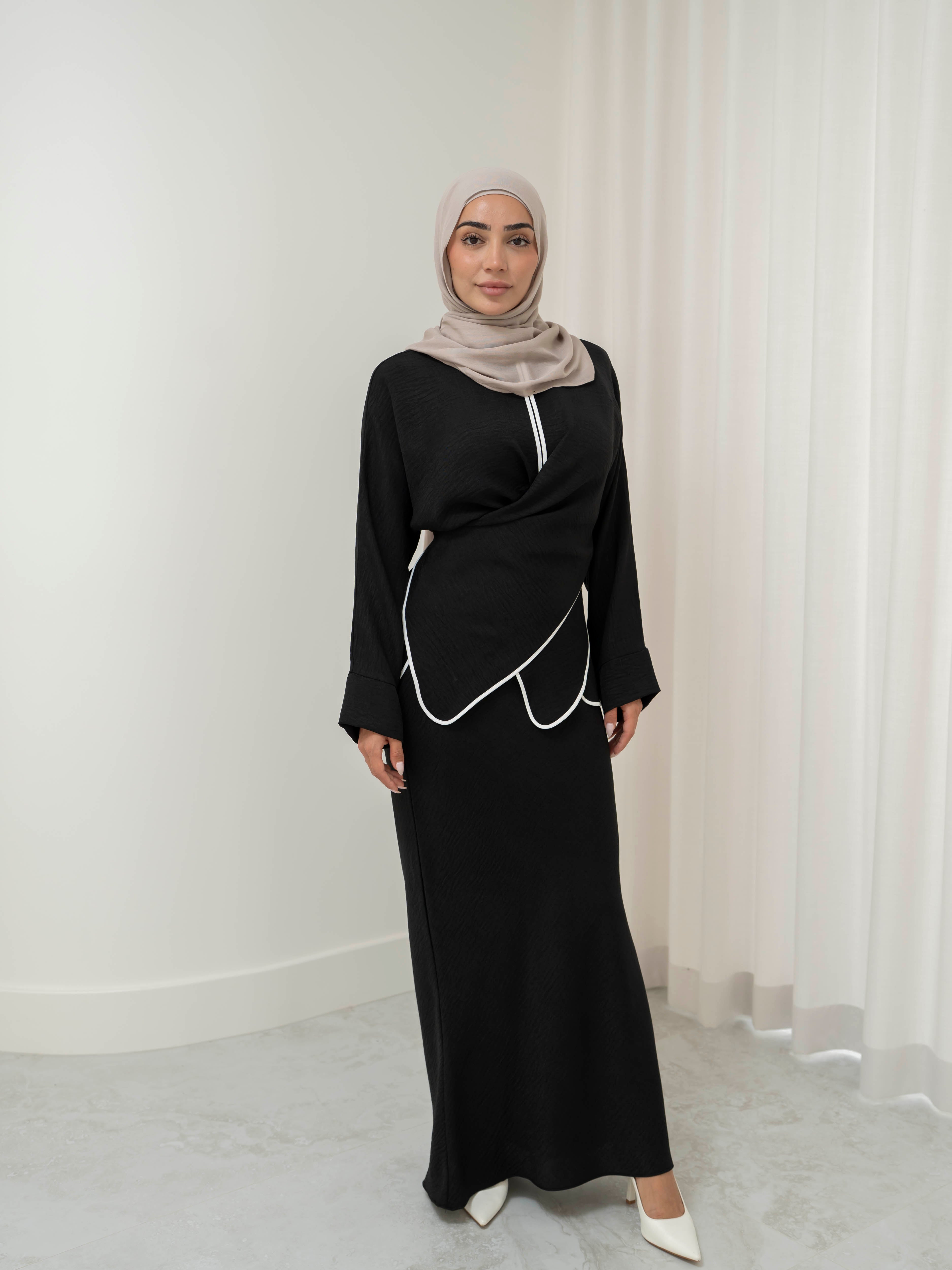 Sienna Wrap Set, a two-piece outfit with a wrap-style tie top featuring contrast piping and long sleeves, paired with a full-length flowing skirt. Lightweight fabric drapes elegantly for a modest, refined silhouette suitable for Eid, special occasions, or versatile everyday wear.
