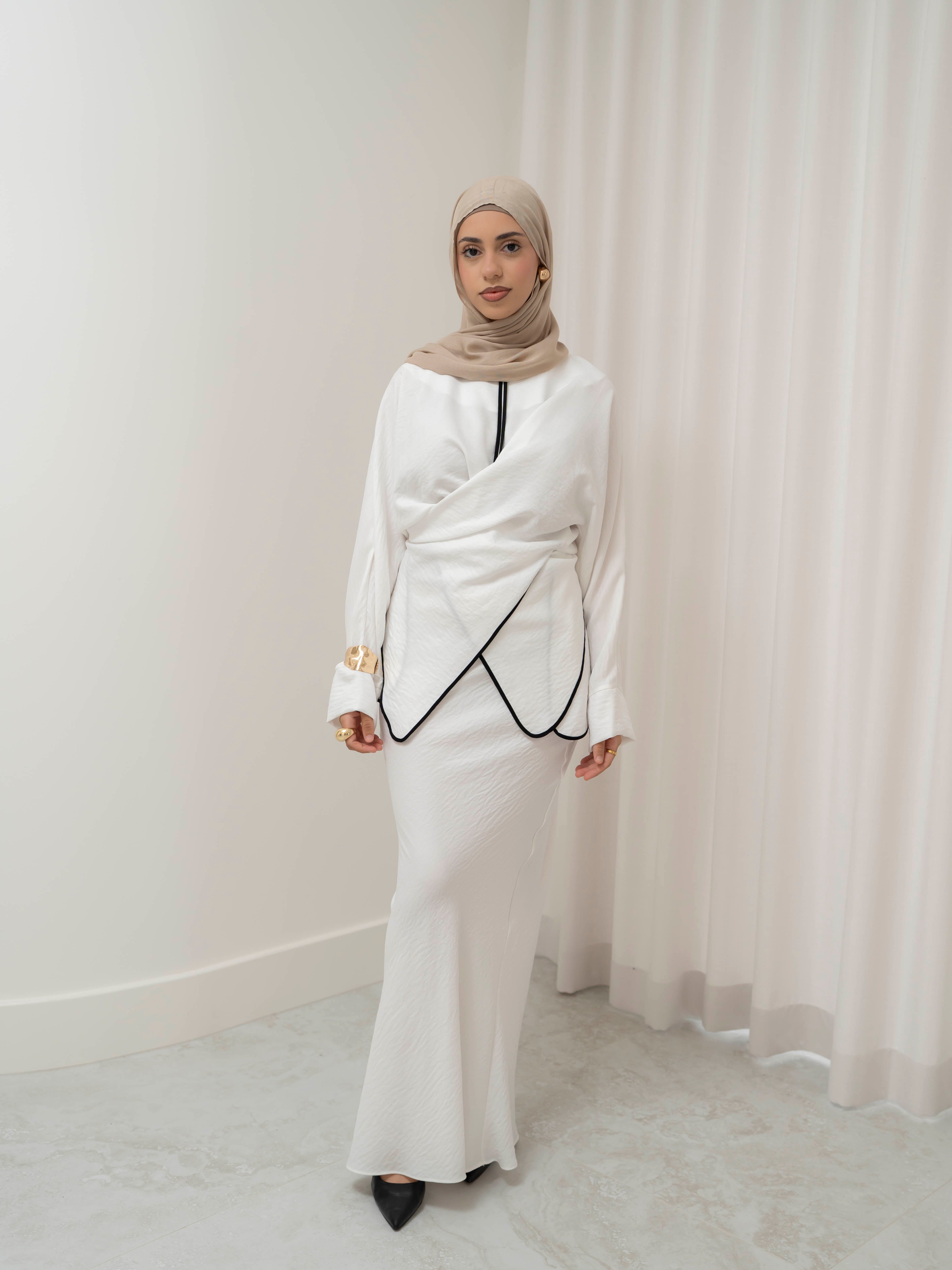 Sienna Wrap Set, a two-piece outfit with a wrap-style tie top featuring contrast piping and long sleeves, paired with a full-length flowing skirt. Lightweight fabric drapes elegantly for a modest, refined silhouette suitable for Eid, special occasions, or versatile everyday wear.