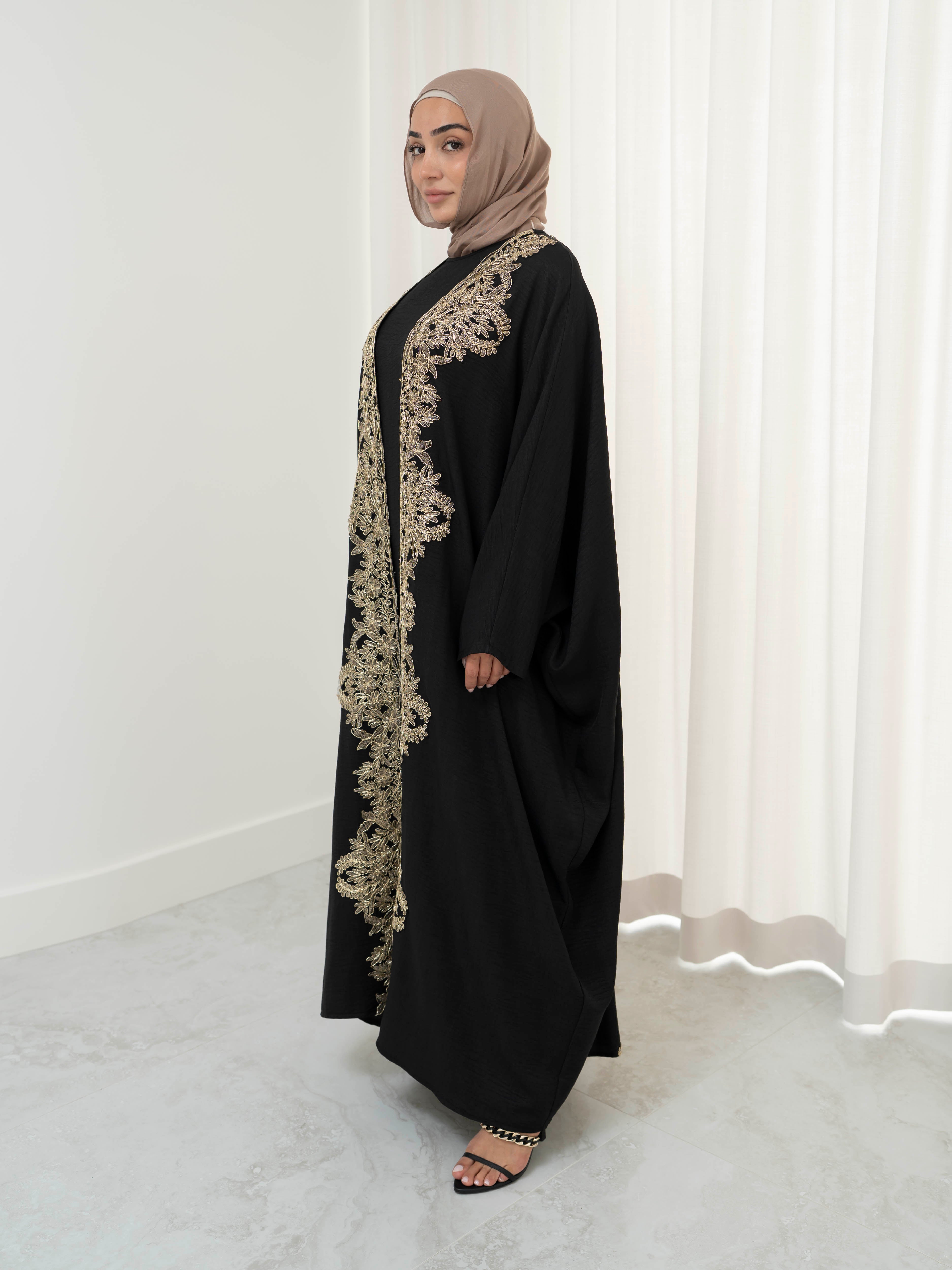 Sultanah Abaya with flowing silhouette and intricate gold embroidery, designed for elegant, modest formal wear. Features delicate gold detailing for a refined, regal finish and includes a sleeveless inner dress for comfortable layering. Perfect for Eid, special occasions, and formal gatherings.