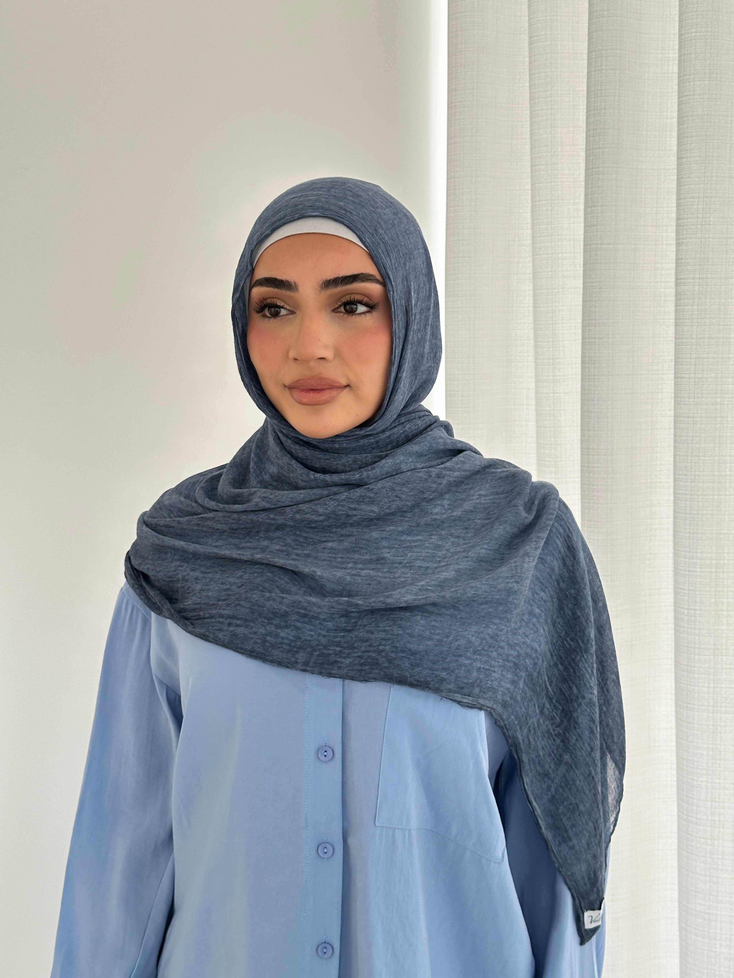 Crafted from soft rayon, this textured hijab drapes effortlessly while offering a breathable and lightweight feel. 