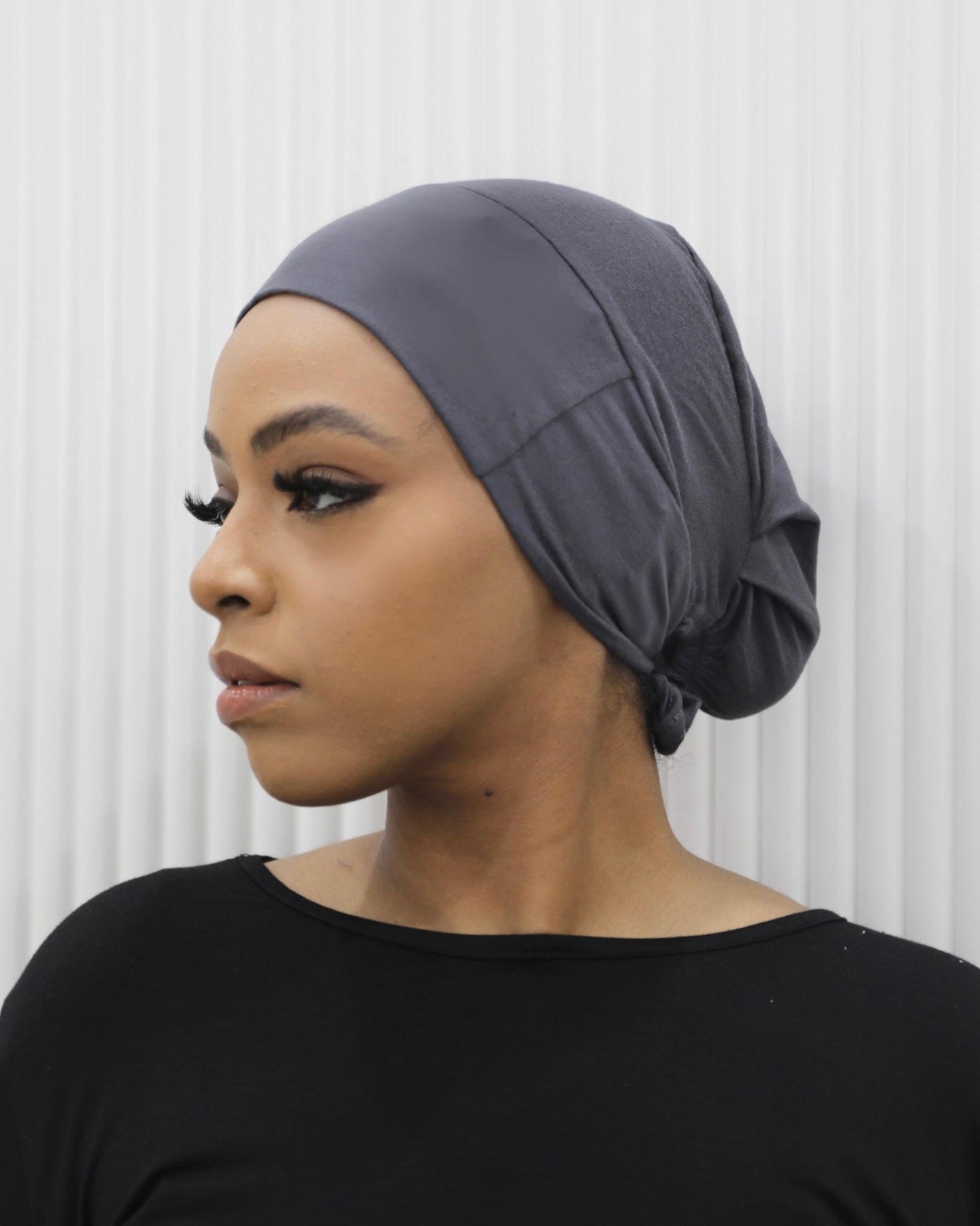 Tie Back Cap in bronze colour, featuring an adjustable strap at the back for a comfortable fit.