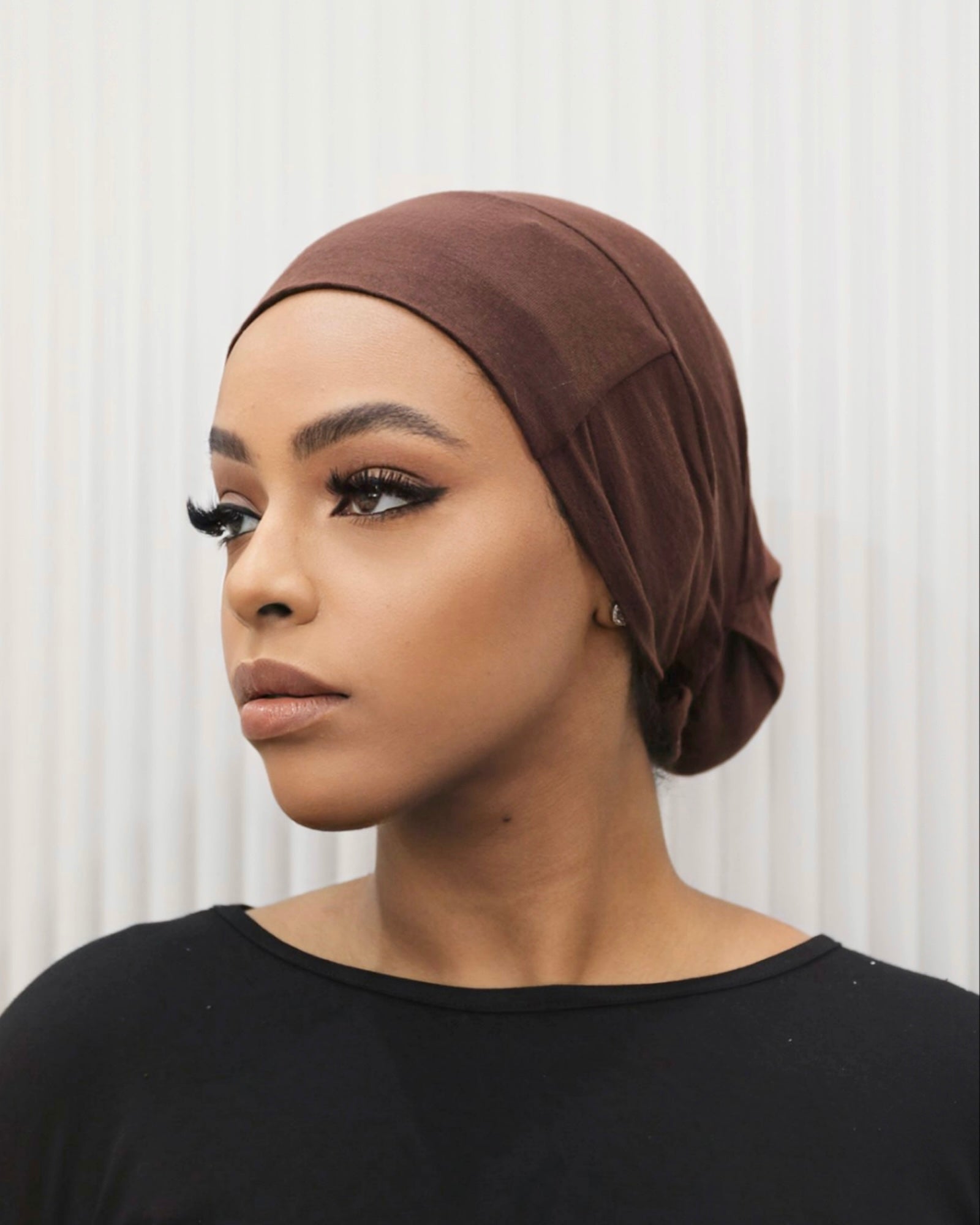 Tie Back Cap in chocolate colour, featuring an adjustable strap at the back for a comfortable fit.