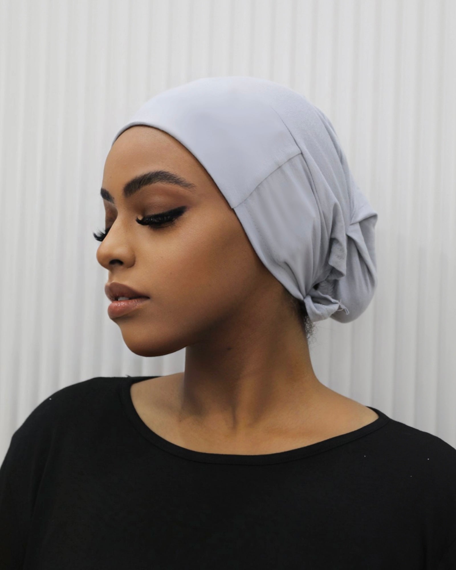 Tie Back Cap in bronze colour, featuring an adjustable strap at the back for a comfortable fit.