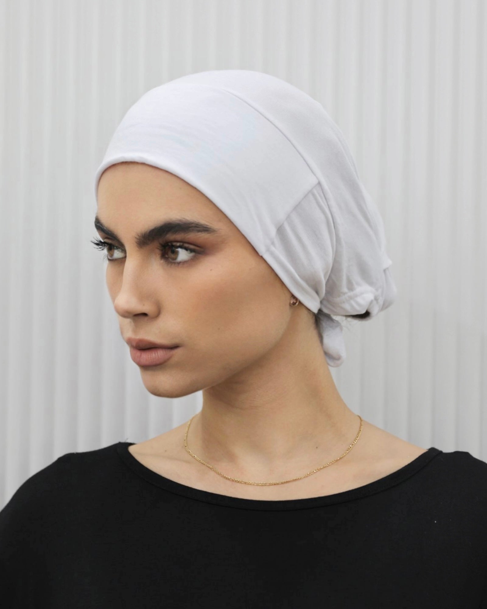 Tie Back Cap in white color, featuring an adjustable strap at the back for a comfortable fit.