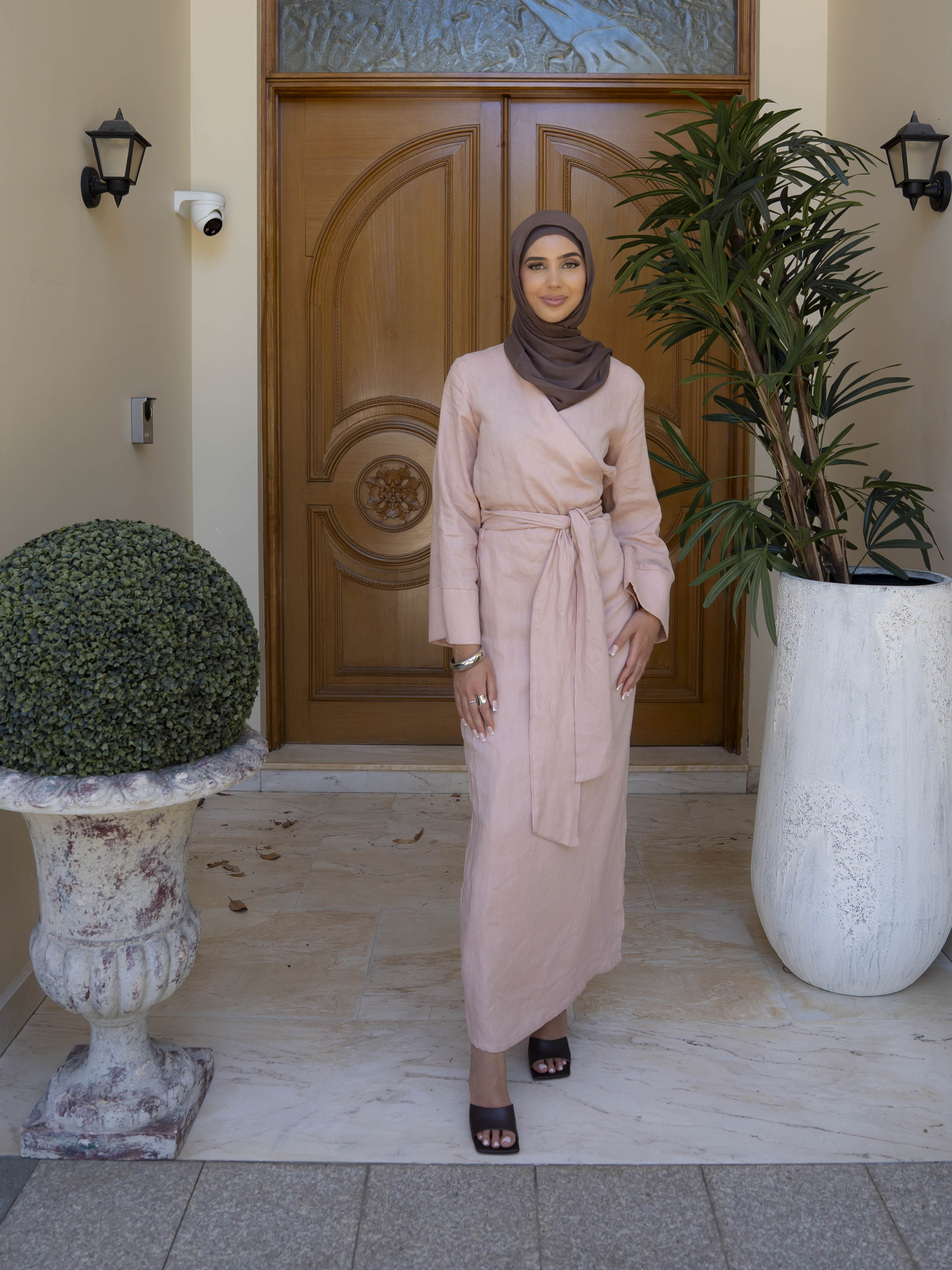 Model wearing the Linen Kimono Wrap featuring a relaxed silhouette in breathable linen fabric, styled as a wrap for a modest and effortless look.