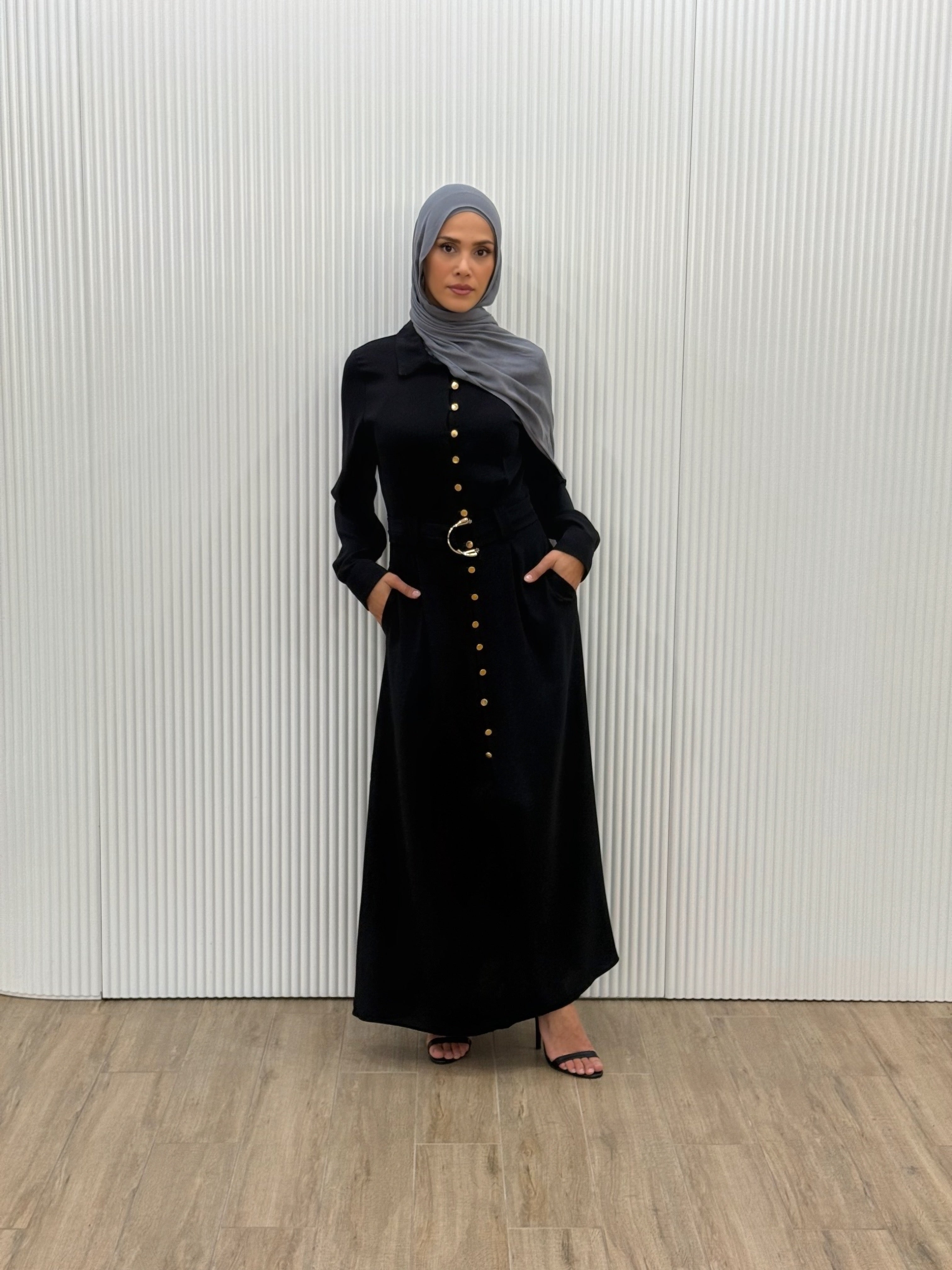  Crafted from a lightweight crepe blend, it features gold-tone buttons, cuffed sleeves, and a removable waist belt that cinches the silhouette beautifully. 