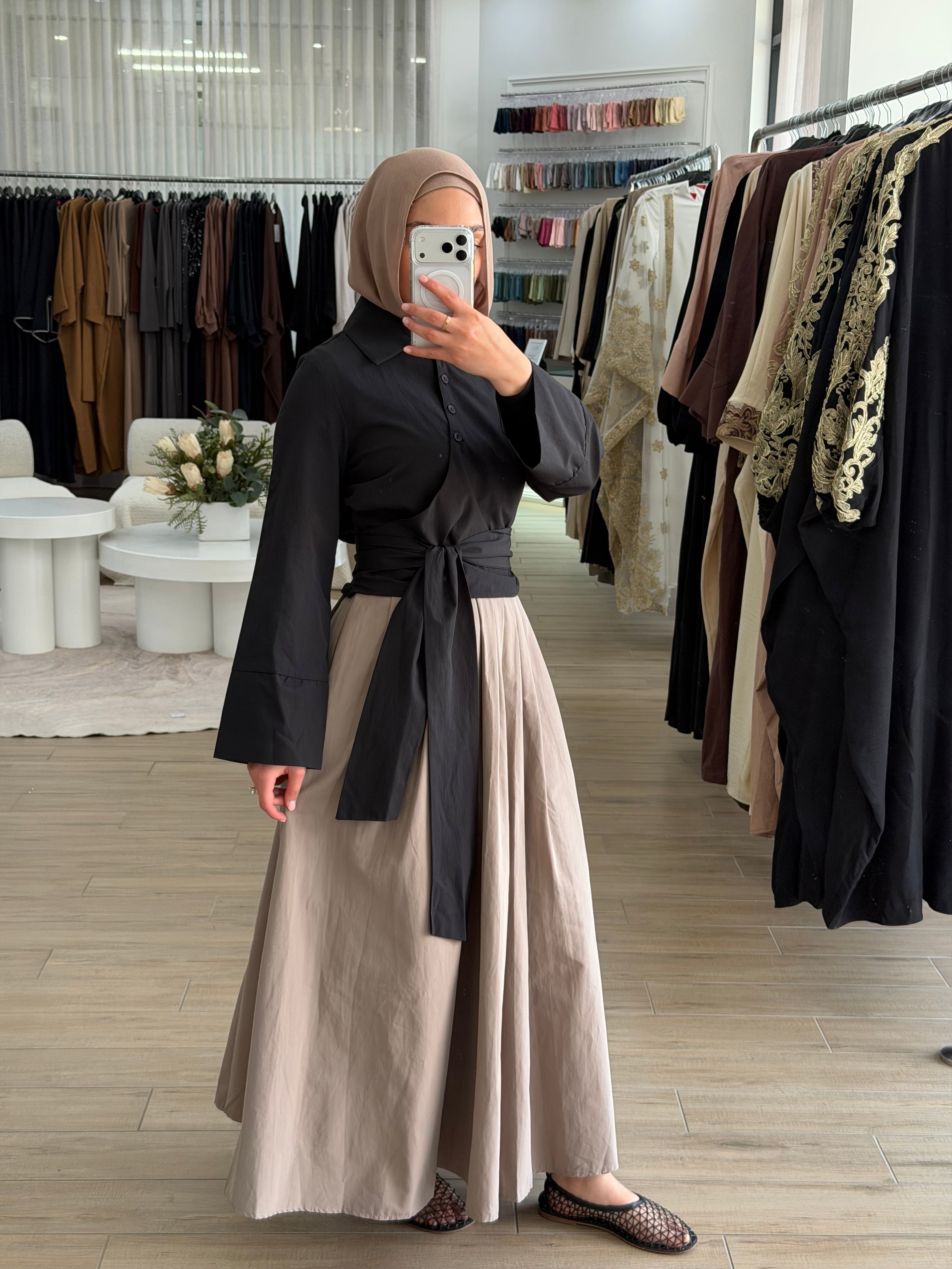 Woman wearing the Amara flow skirt, featuring a high-waisted fit and fluid, modest silhouette.