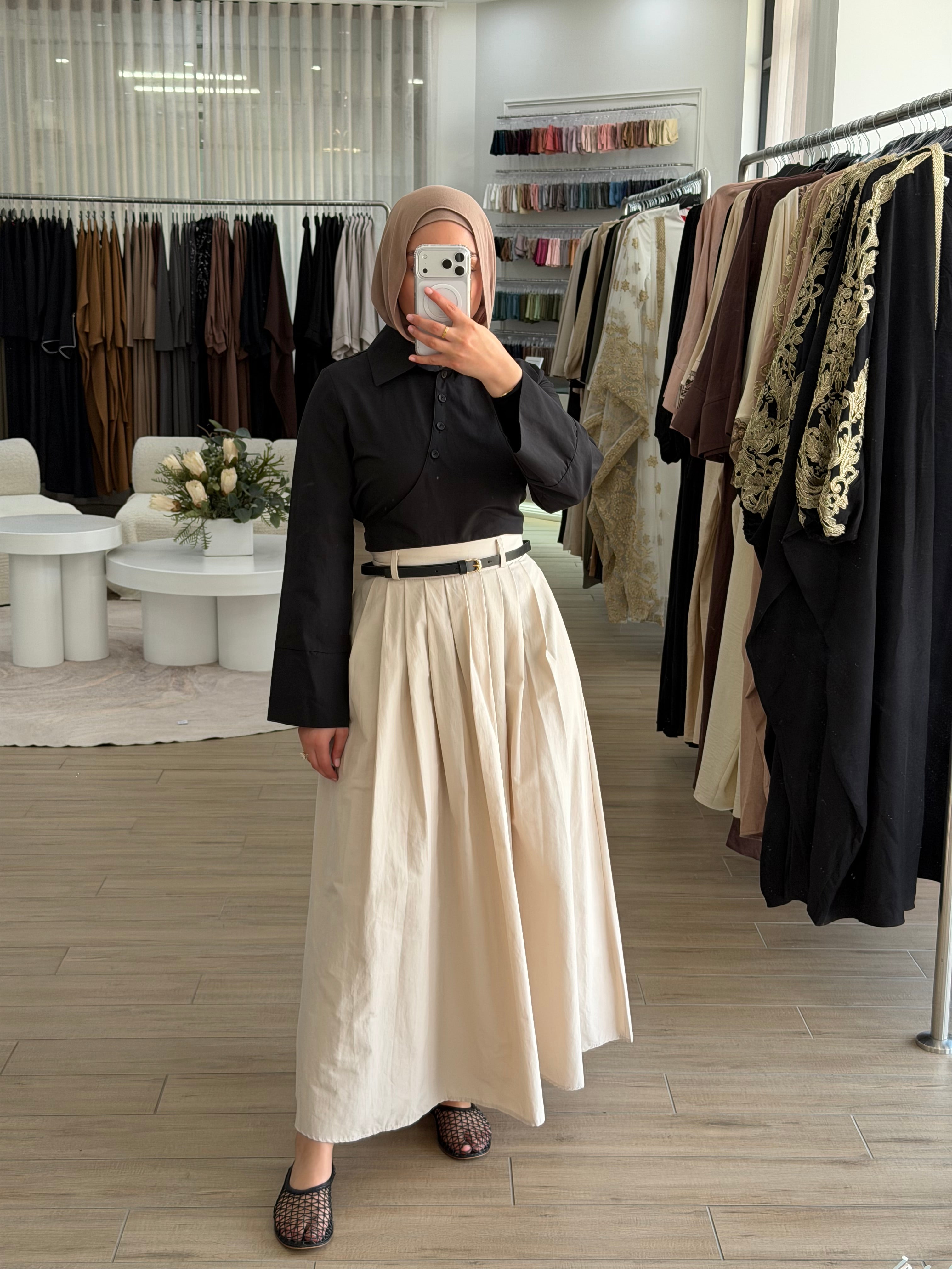 Woman wearing the Amara flow skirt, featuring a high-waisted fit and fluid, modest silhouette.