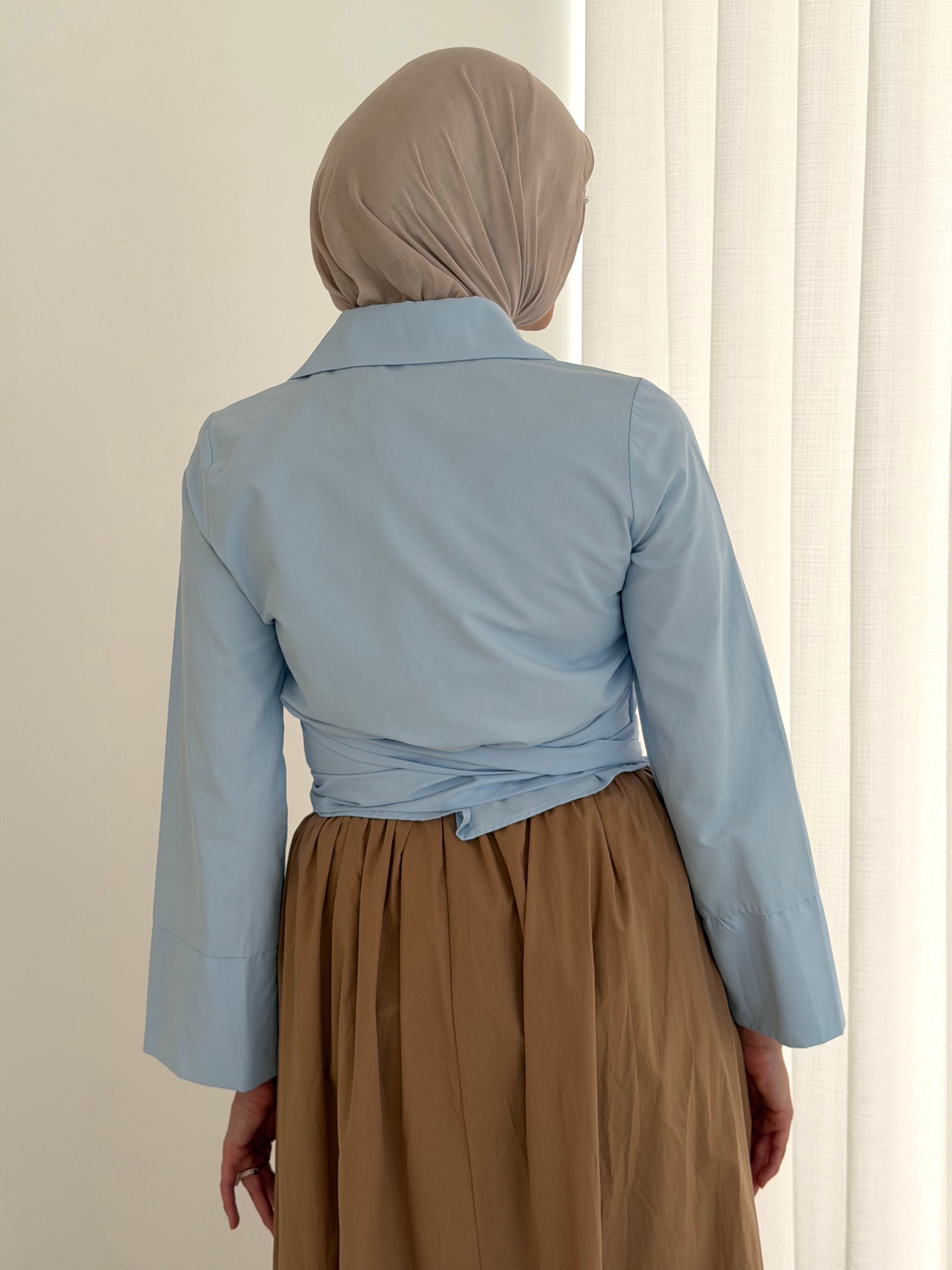 women's button wrap shirt with tie, collar and long sleeves in baby blue and white. top for hijabi friendly, modest fashion.