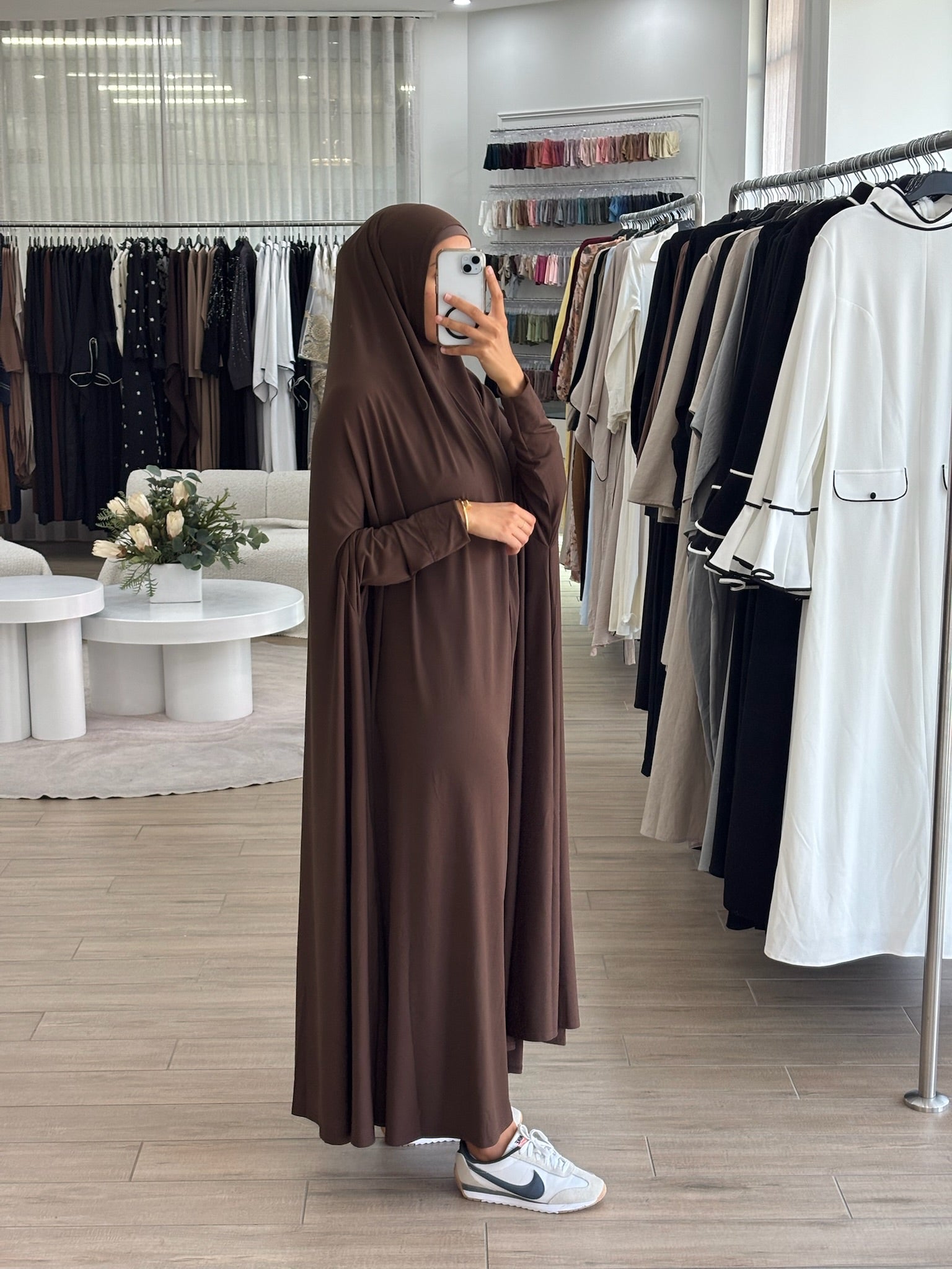 Model wearing a floor-length jilbab with a loose, flowing silhouette, styled for comfortable and modest everyday wear.