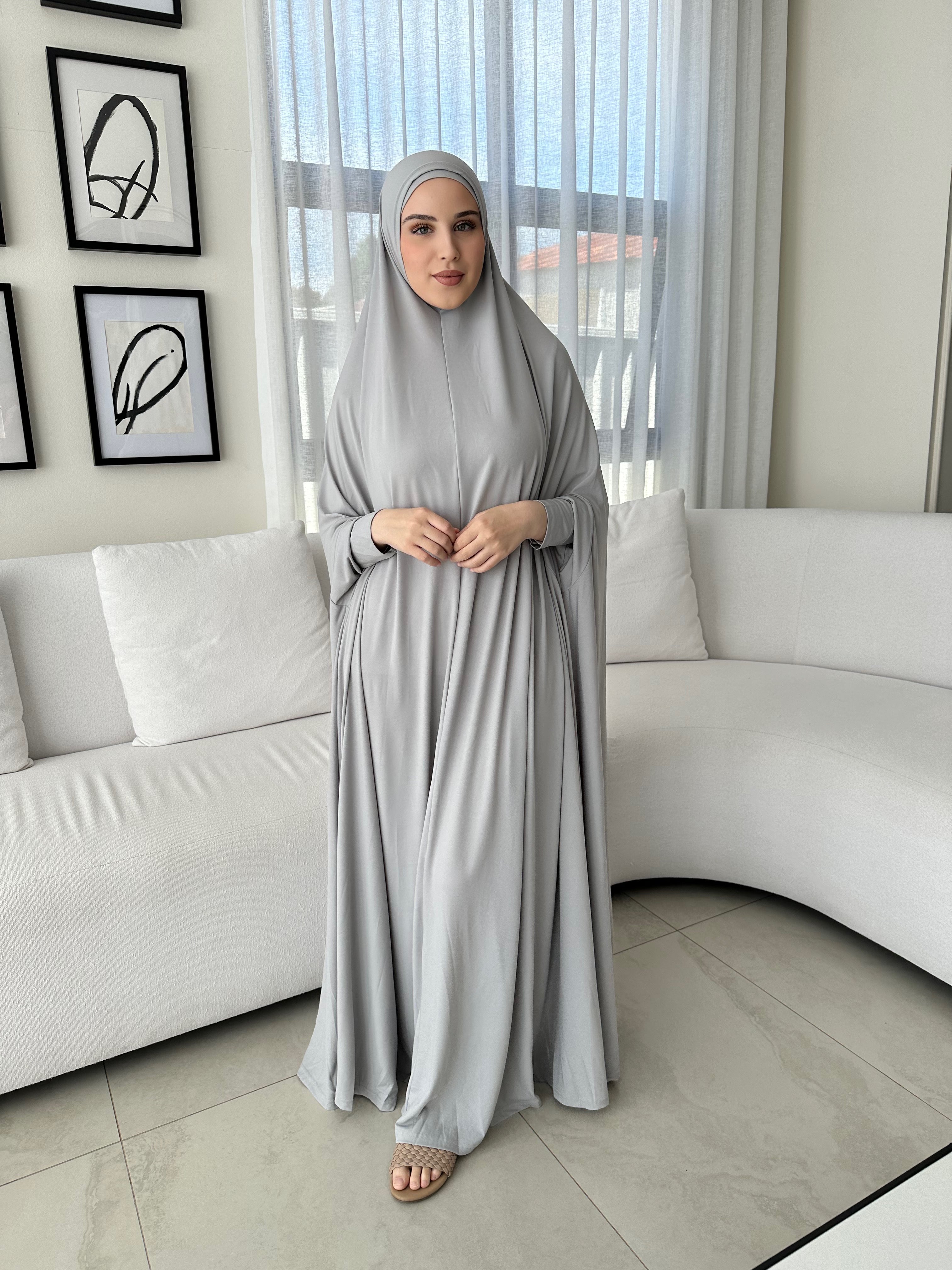 Model wearing a floor-length jilbab with a loose, flowing silhouette, styled for comfortable and modest everyday wear.