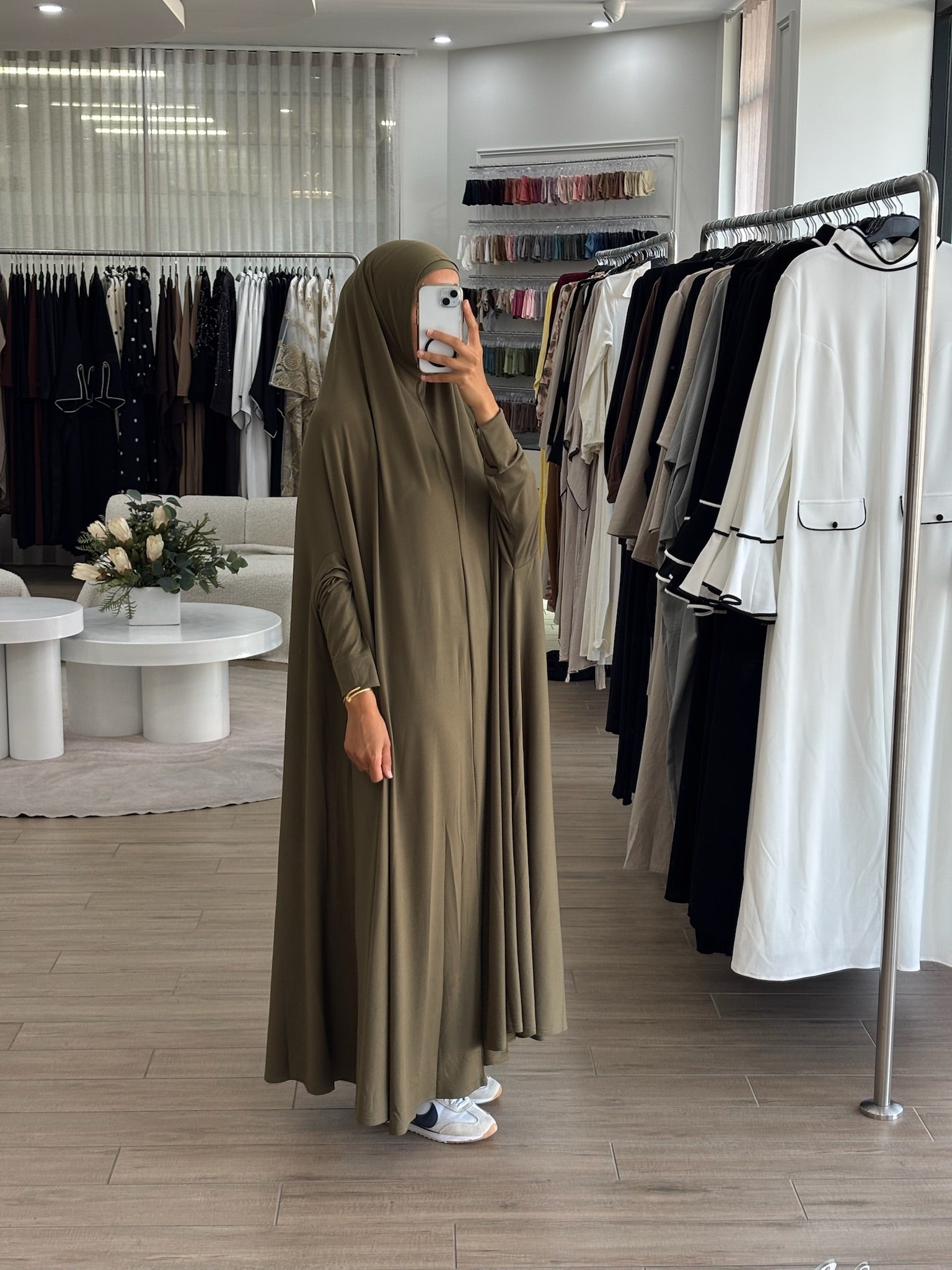 Model wearing a floor-length jilbab with a loose, flowing silhouette, styled for comfortable and modest everyday wear.