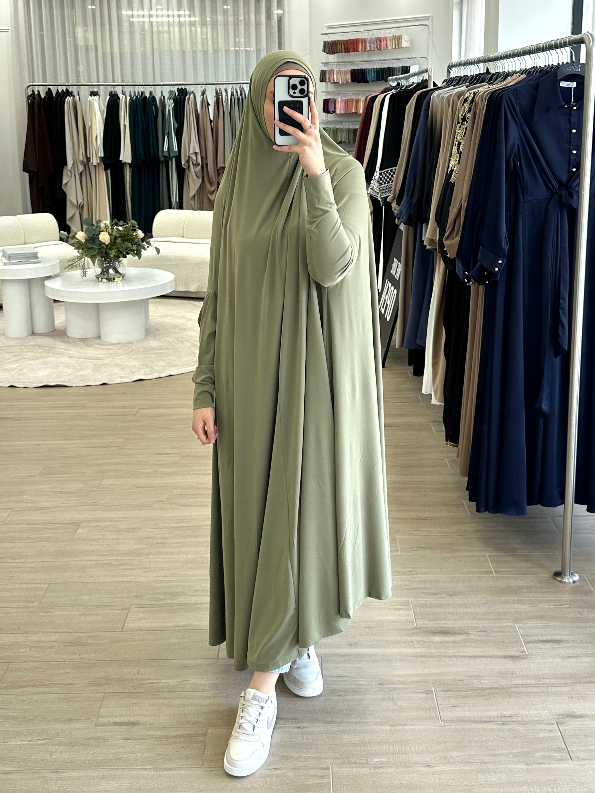 Model wearing a floor-length jilbab with a loose, flowing silhouette, styled for comfortable and modest everyday wear.