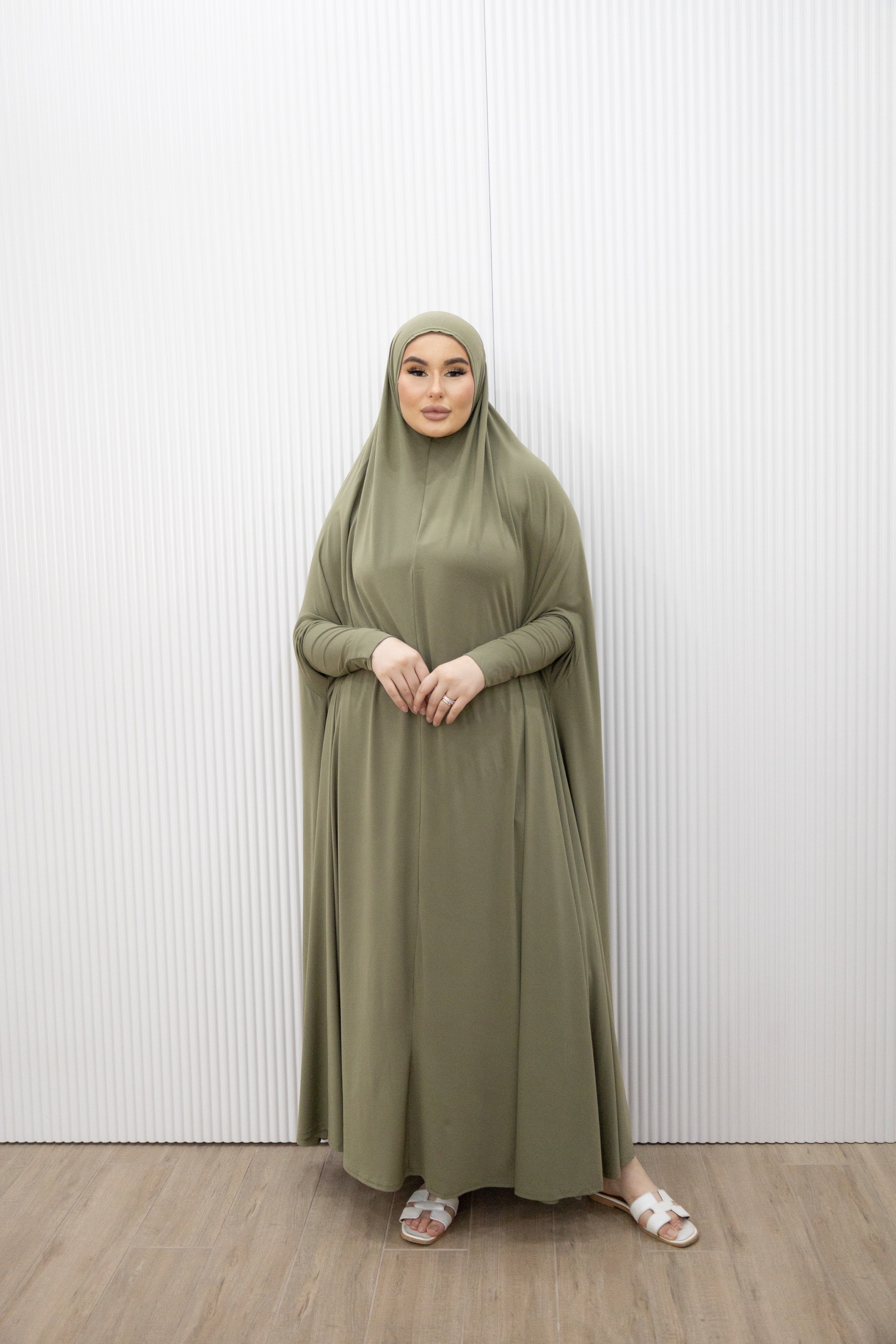Model wearing a floor-length jilbab with a loose, flowing silhouette, styled for comfortable and modest everyday wear.