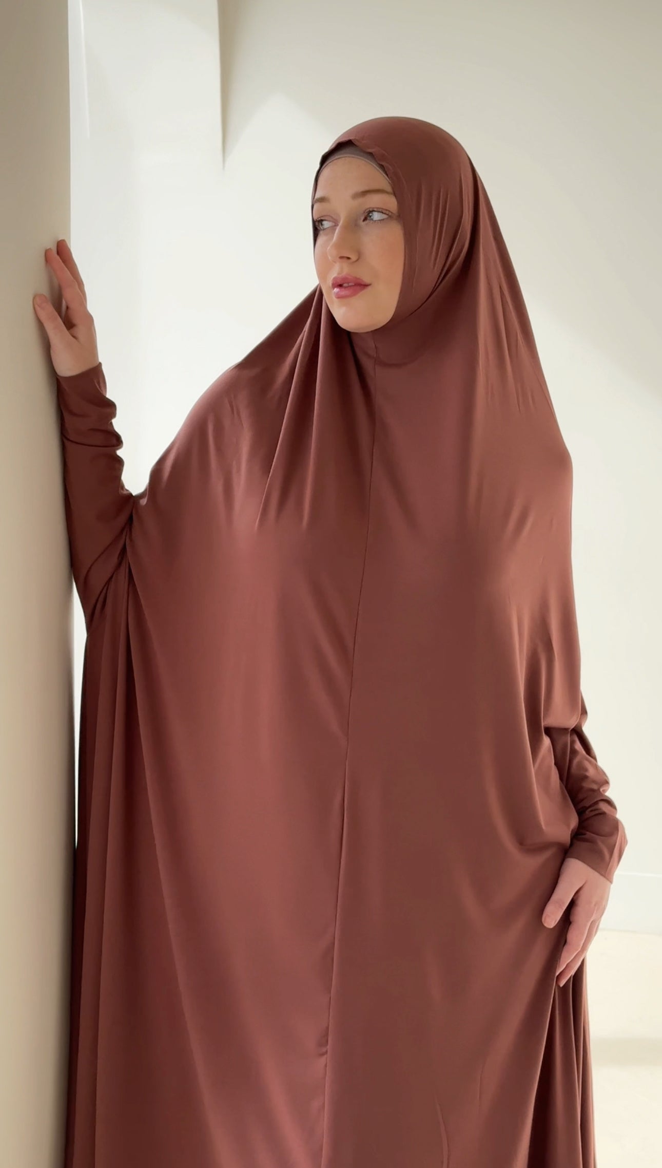 Model wearing a floor-length jilbab with a loose, flowing silhouette, styled for comfortable and modest everyday wear.