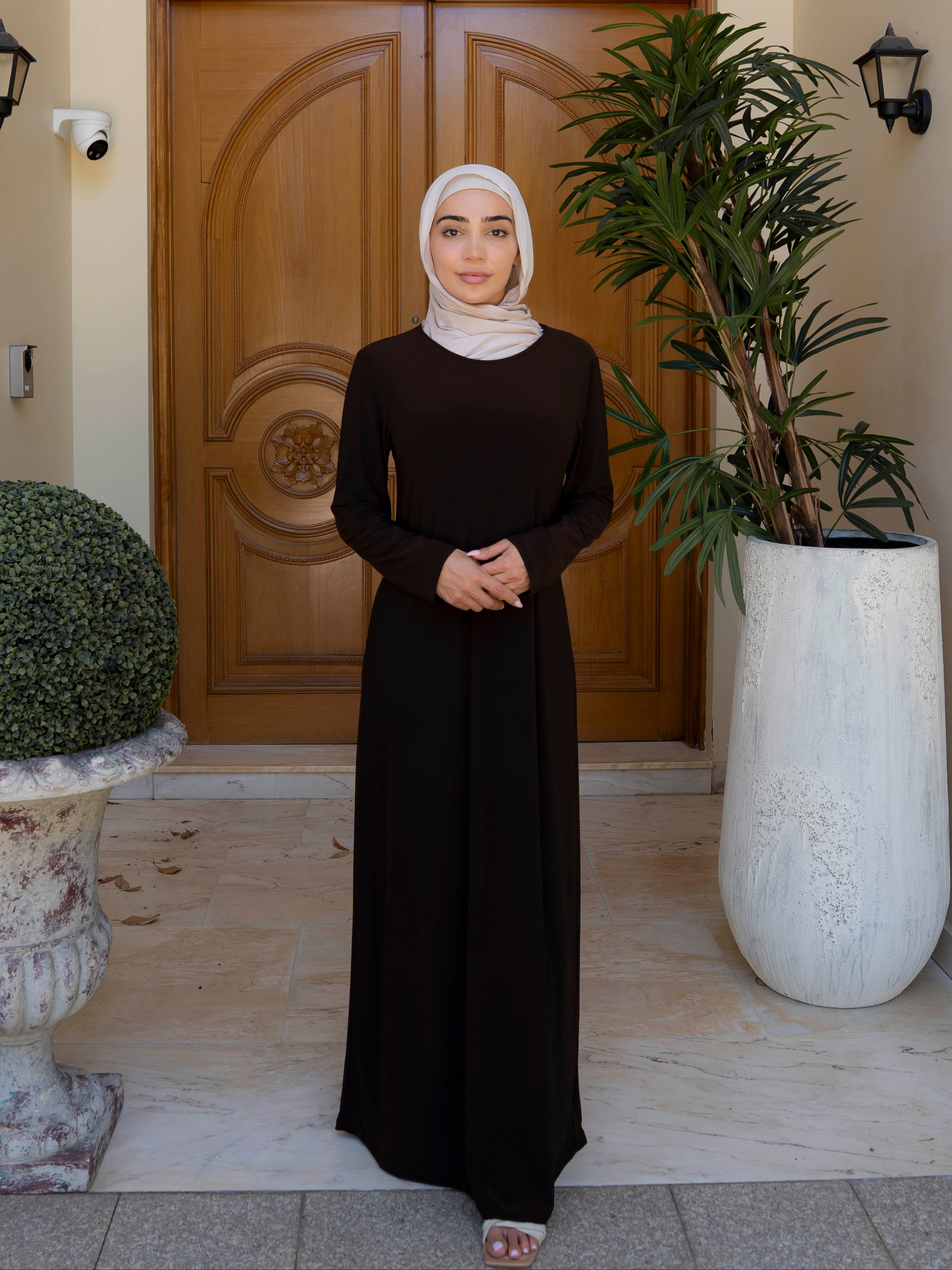 Model wearing the Staple Lycra dress featuring a smooth, streamlined silhouette in stretch lycra fabric, styled for everyday modest wear.