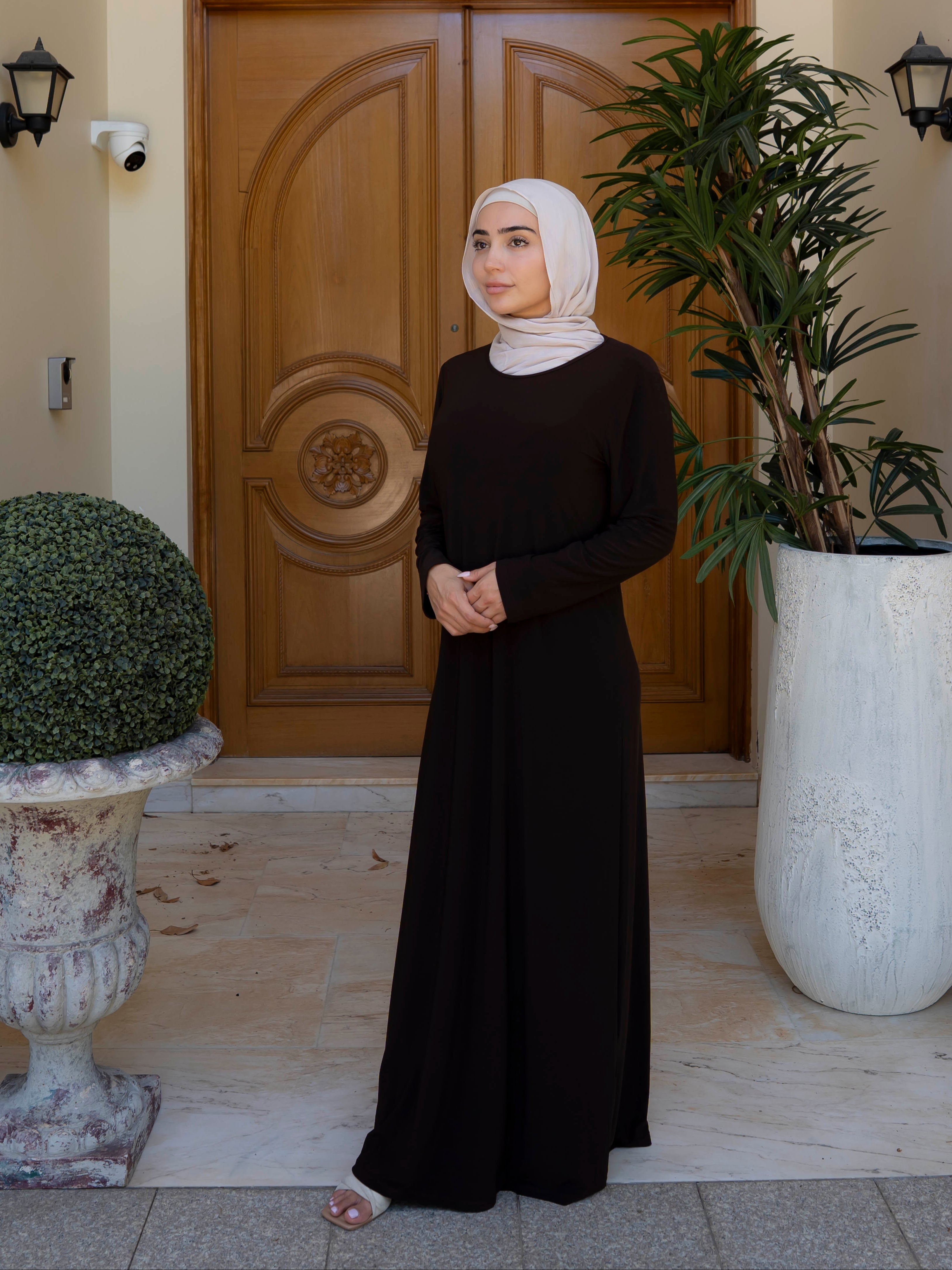 Model wearing the Staple Lycra dress featuring a smooth, streamlined silhouette in stretch lycra fabric, styled for everyday modest wear.