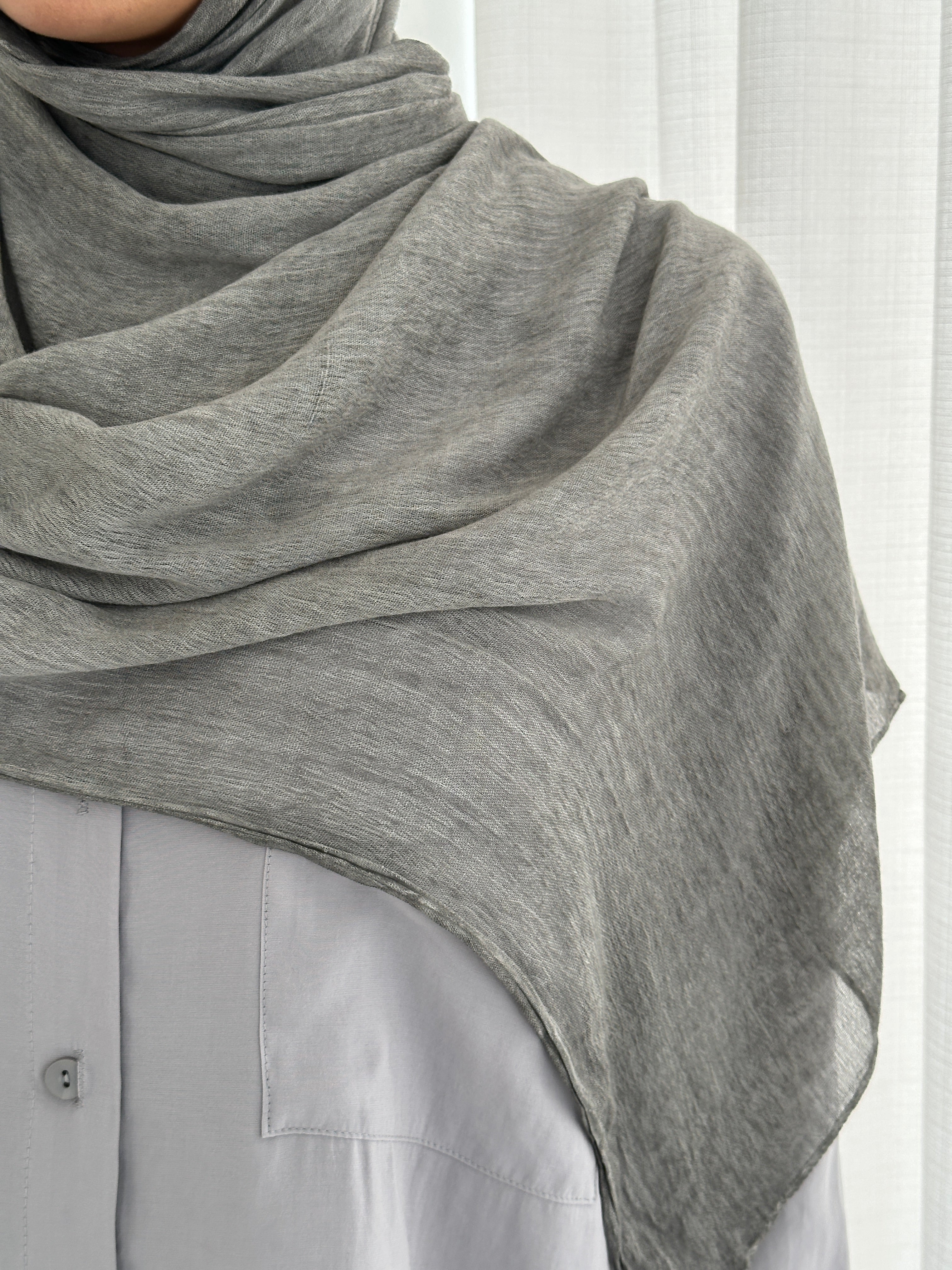 Crafted from soft rayon, this textured hijab drapes effortlessly while offering a breathable and lightweight feel. Its subtle texture adds depth and dimension, perfect for everyday wear.