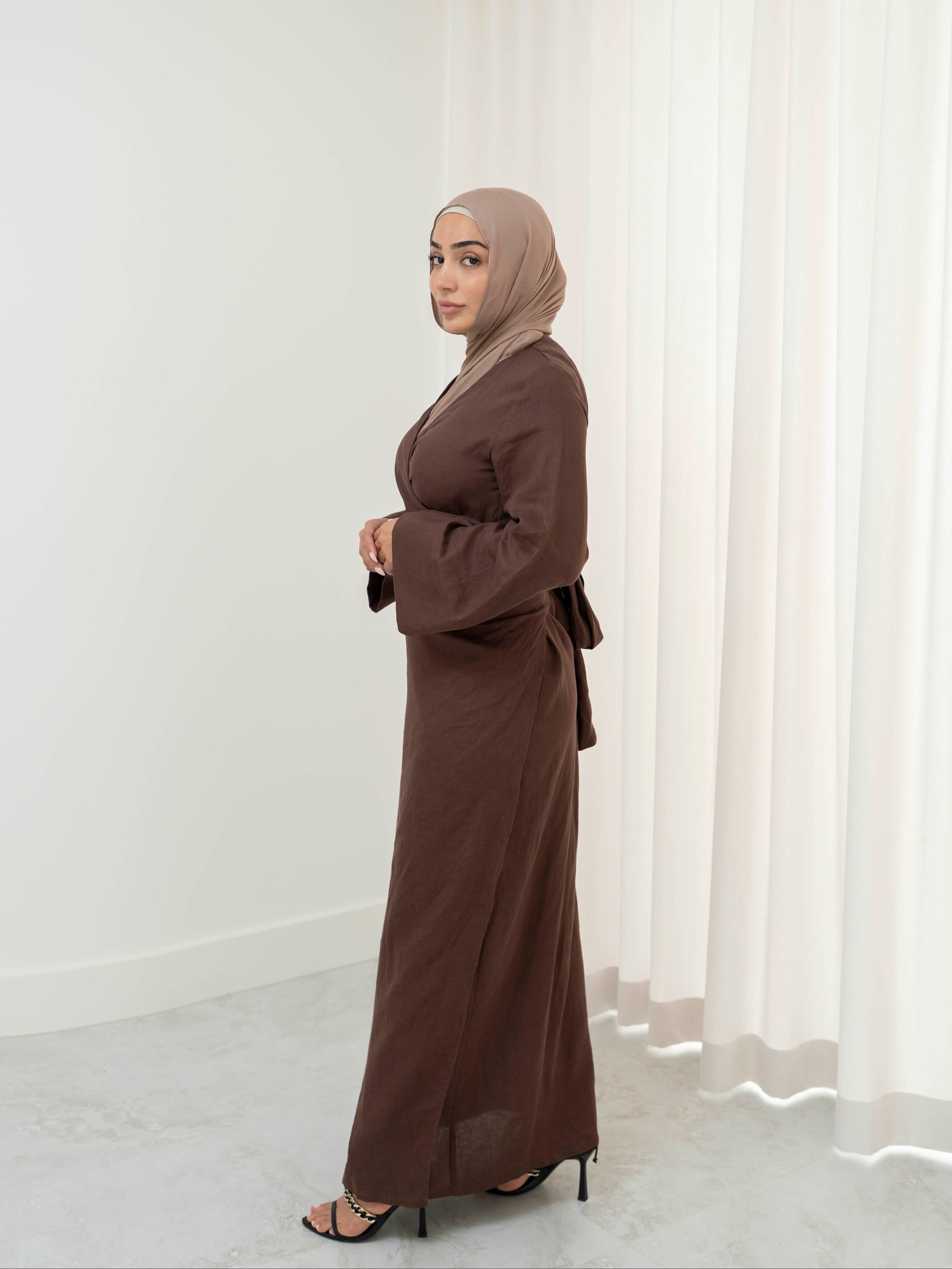Model wearing the Linen Kimono Wrap featuring a relaxed silhouette in breathable linen fabric, styled as a wrap for a modest and effortless look.