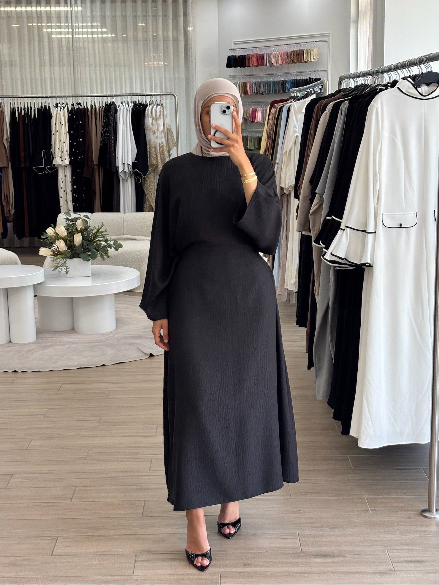 Woman wearing a long wrap two-way dress, featuring an adjustable wrap design and flowing modest silhouette.