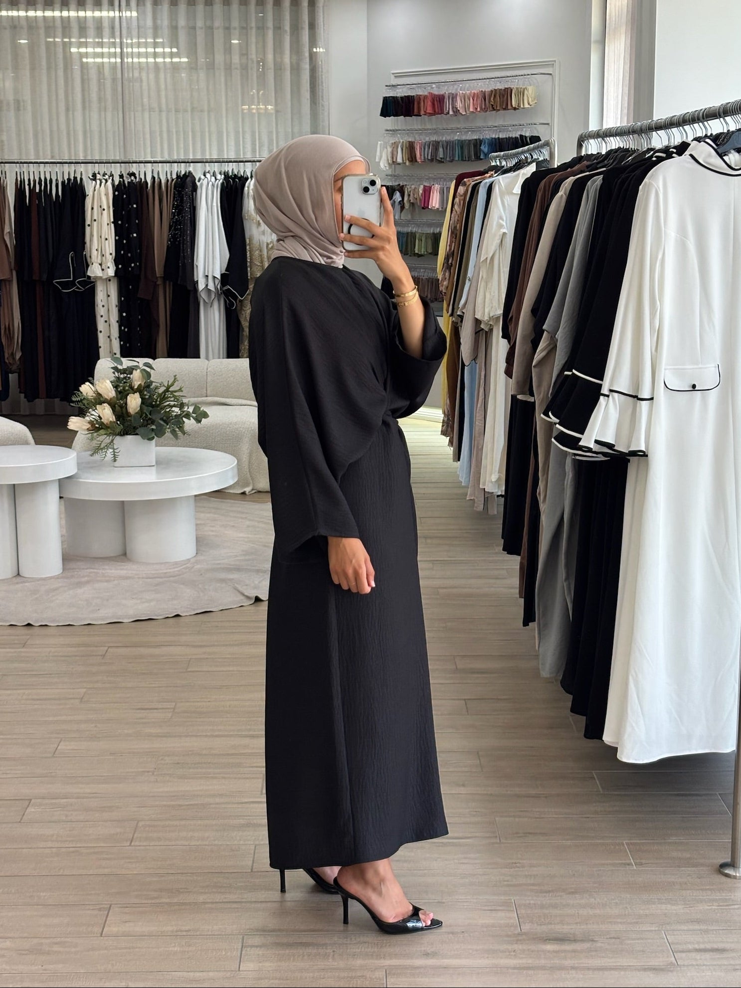 Side view of a long wrap dress with a fluid drape and elegant longline shape.