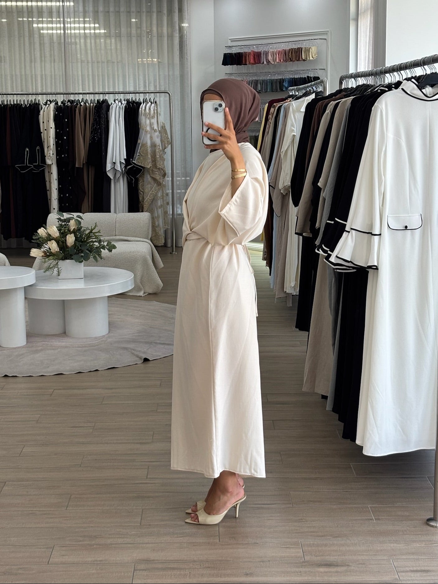Side view of a long wrap dress with a fluid drape and elegant longline shape.