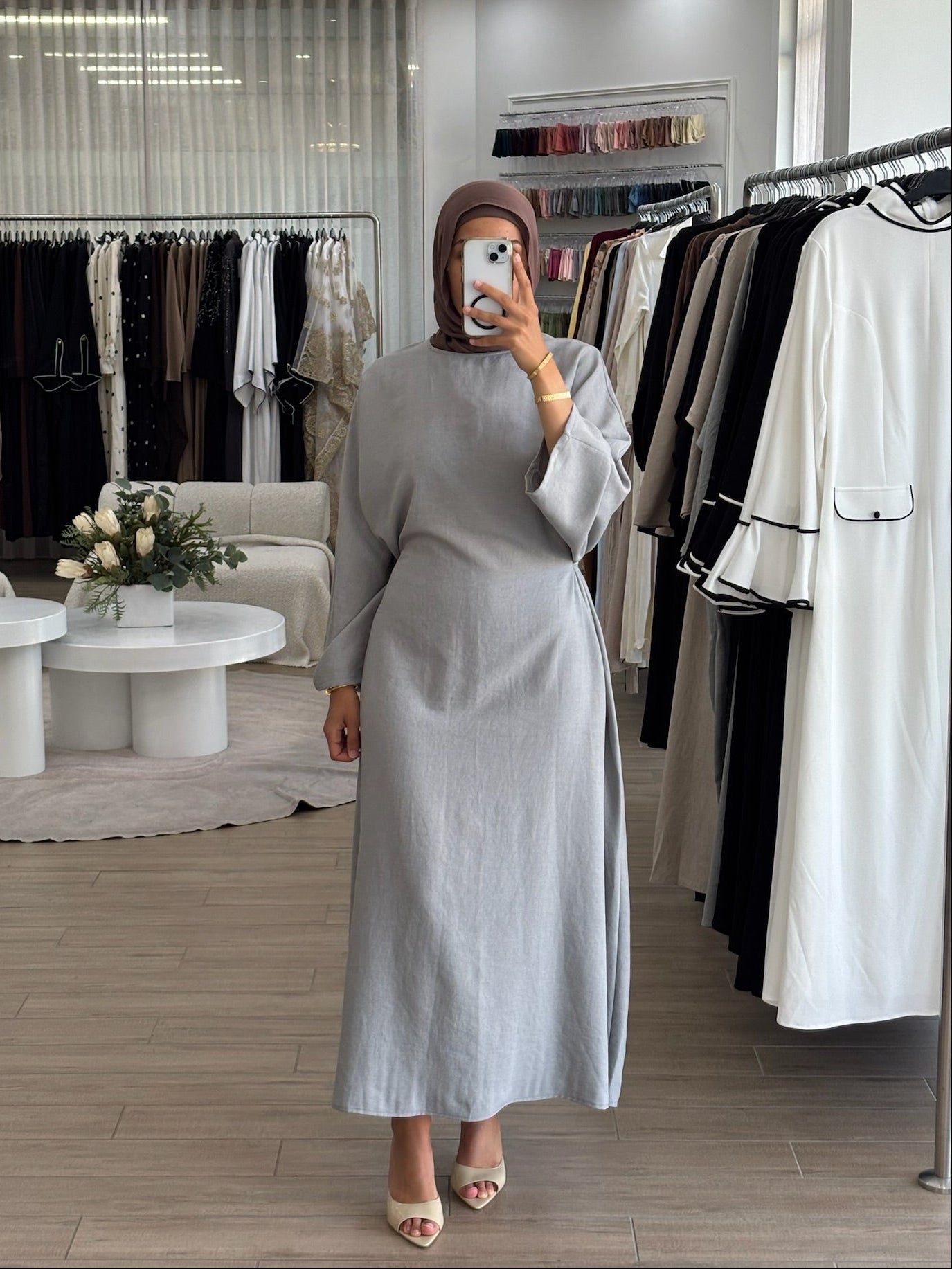 Woman wearing a long wrap two-way dress, featuring an adjustable wrap design and flowing modest silhouette.