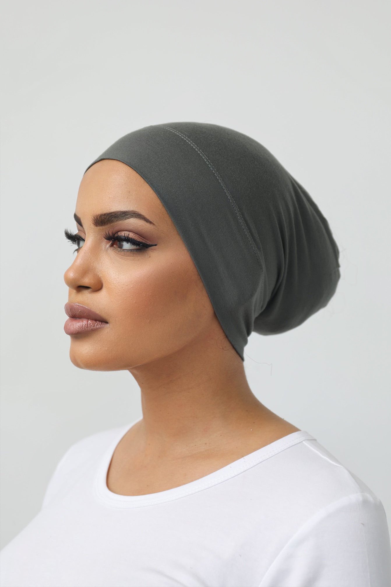 Bamboo under-scarf cap designed to cover hair beneath a hijab, made from soft, breathable natural bamboo fibers with cotton spandex stretch for comfort. Partially closed at the back with an elastic edge to comfortably accommodate hair.