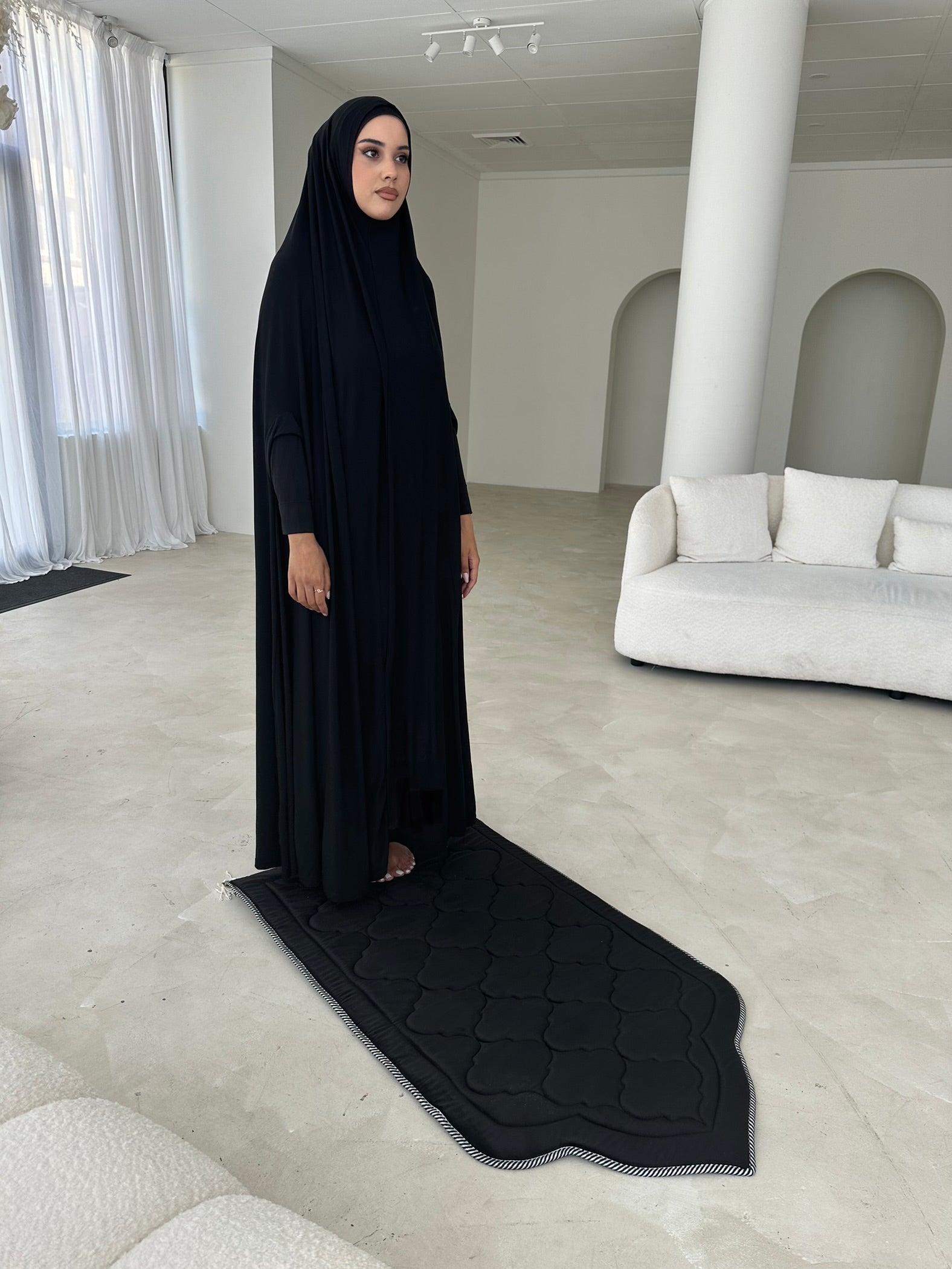 Model wearing a floor-length jilbab with a loose, flowing silhouette, styled for comfortable and modest everyday wear.